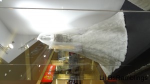A long white dress and veil on a white mannequin