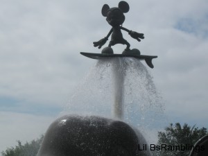 A metal Mickey Mouse surfing a whale's sprout