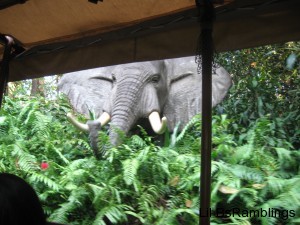 A mechanical elephant face seen through the boat window