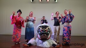My sister and I posing with the men in the shisa dog costume and the lady dancers.